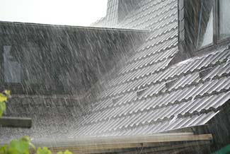 Heavy rain hitting roof of home